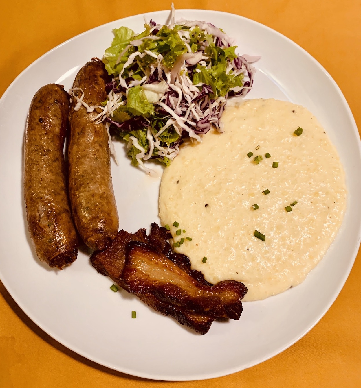 Homemade Craft Sausages with mash, bacon and salad Georges Restaurant