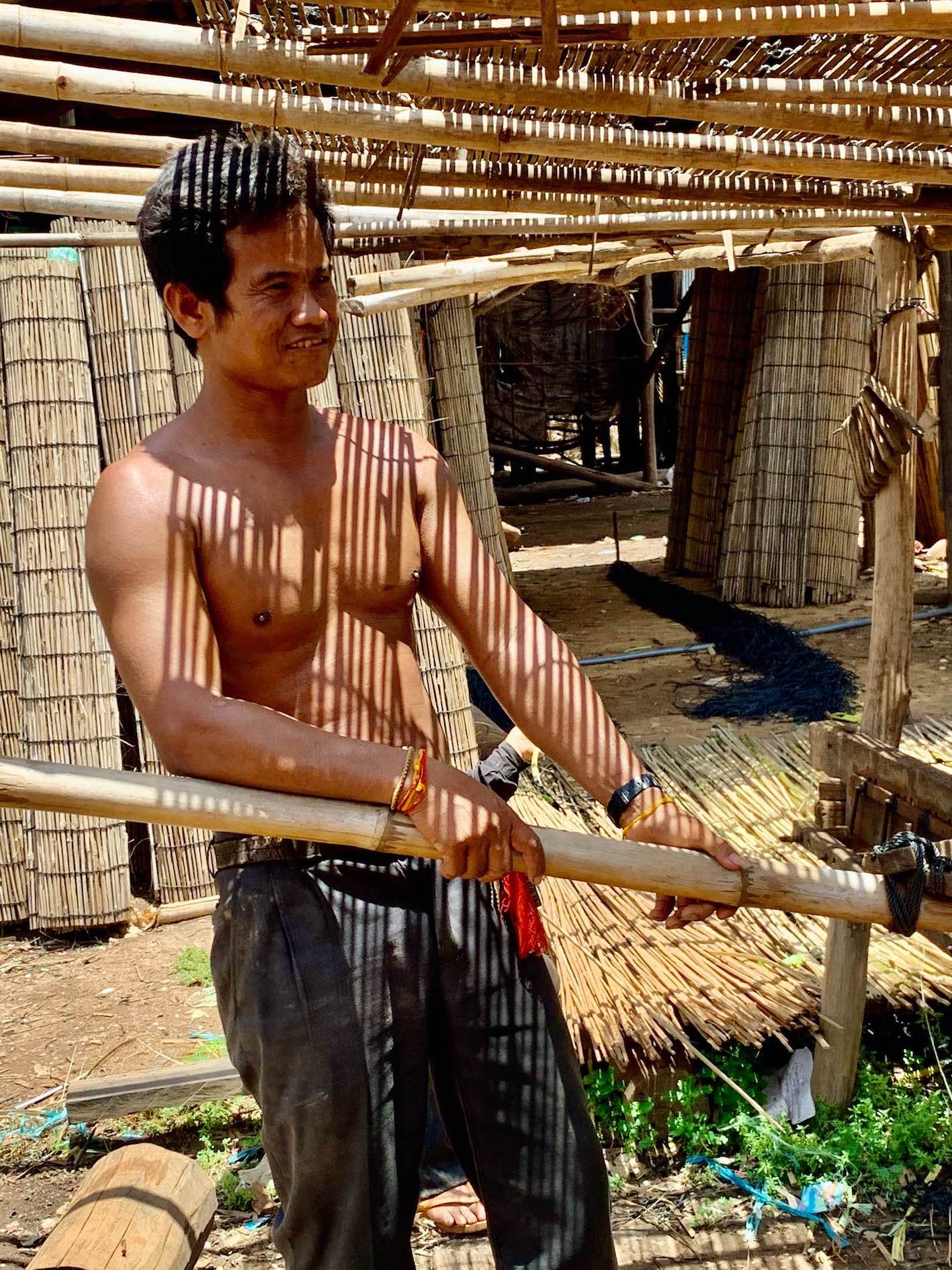 Man weaving bamboo in Cambodia.