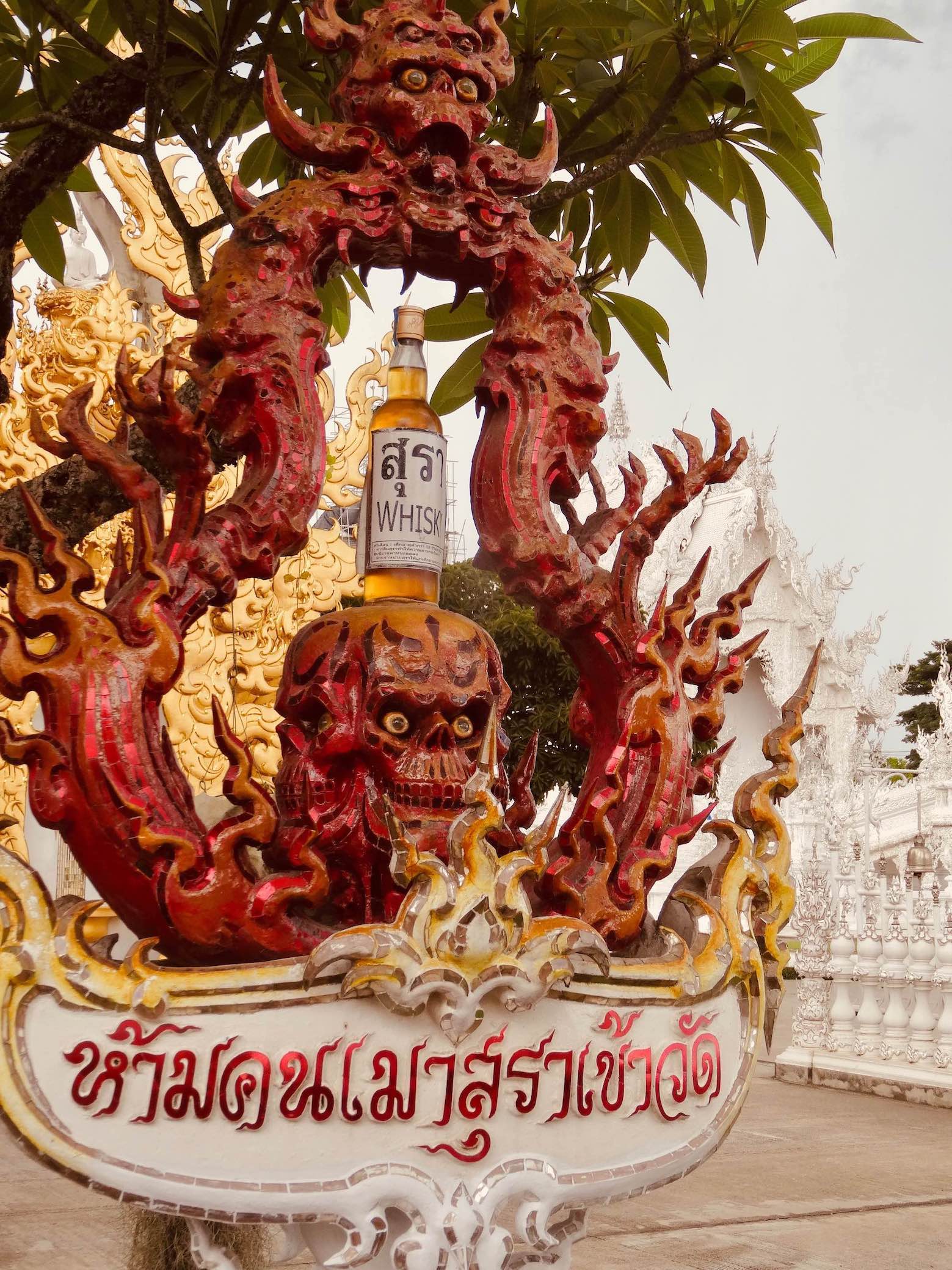 Death skull with whisky at Chiang Rai's White Temple