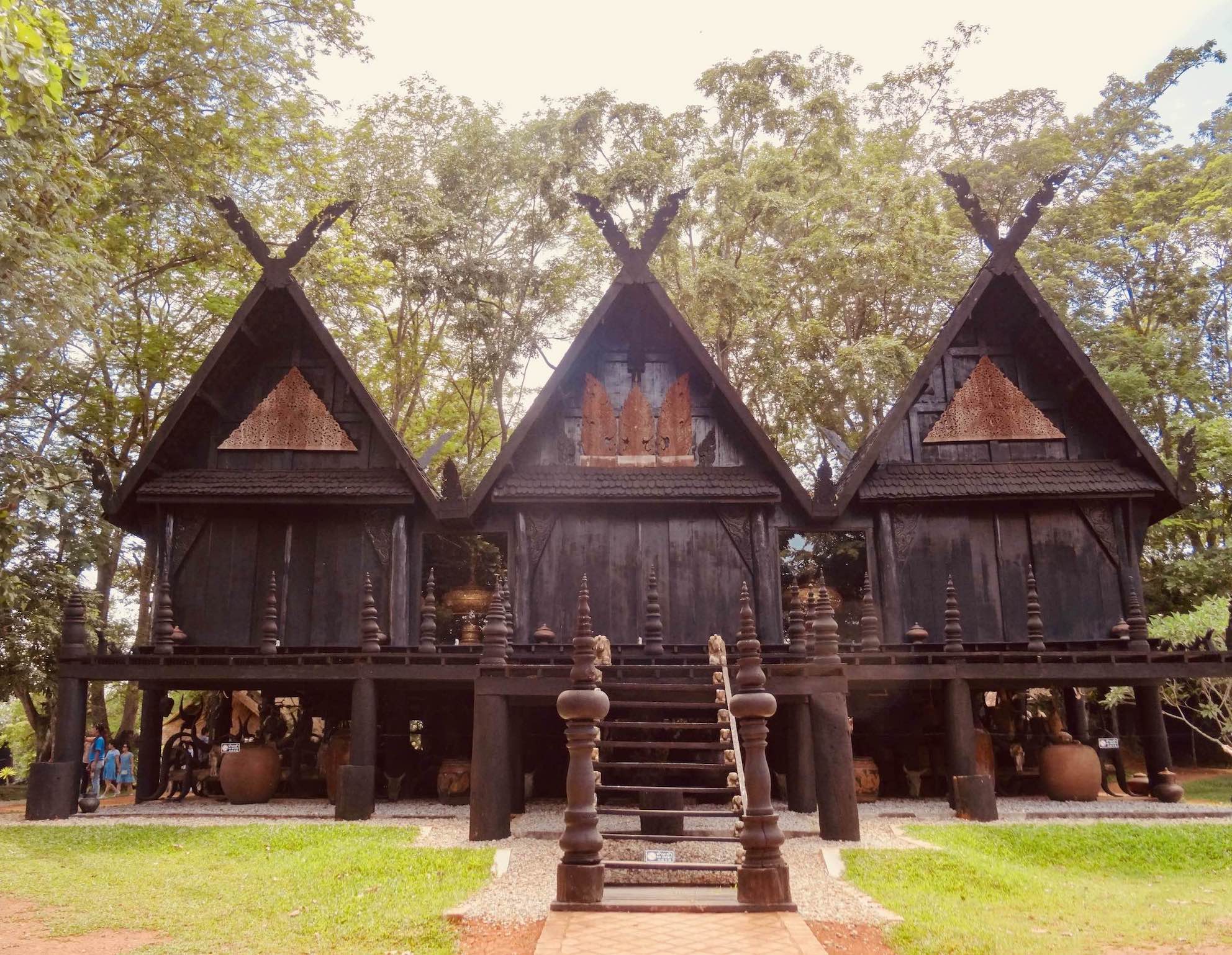 The dark wooden structures of The Black House Museum in Chiang Rai