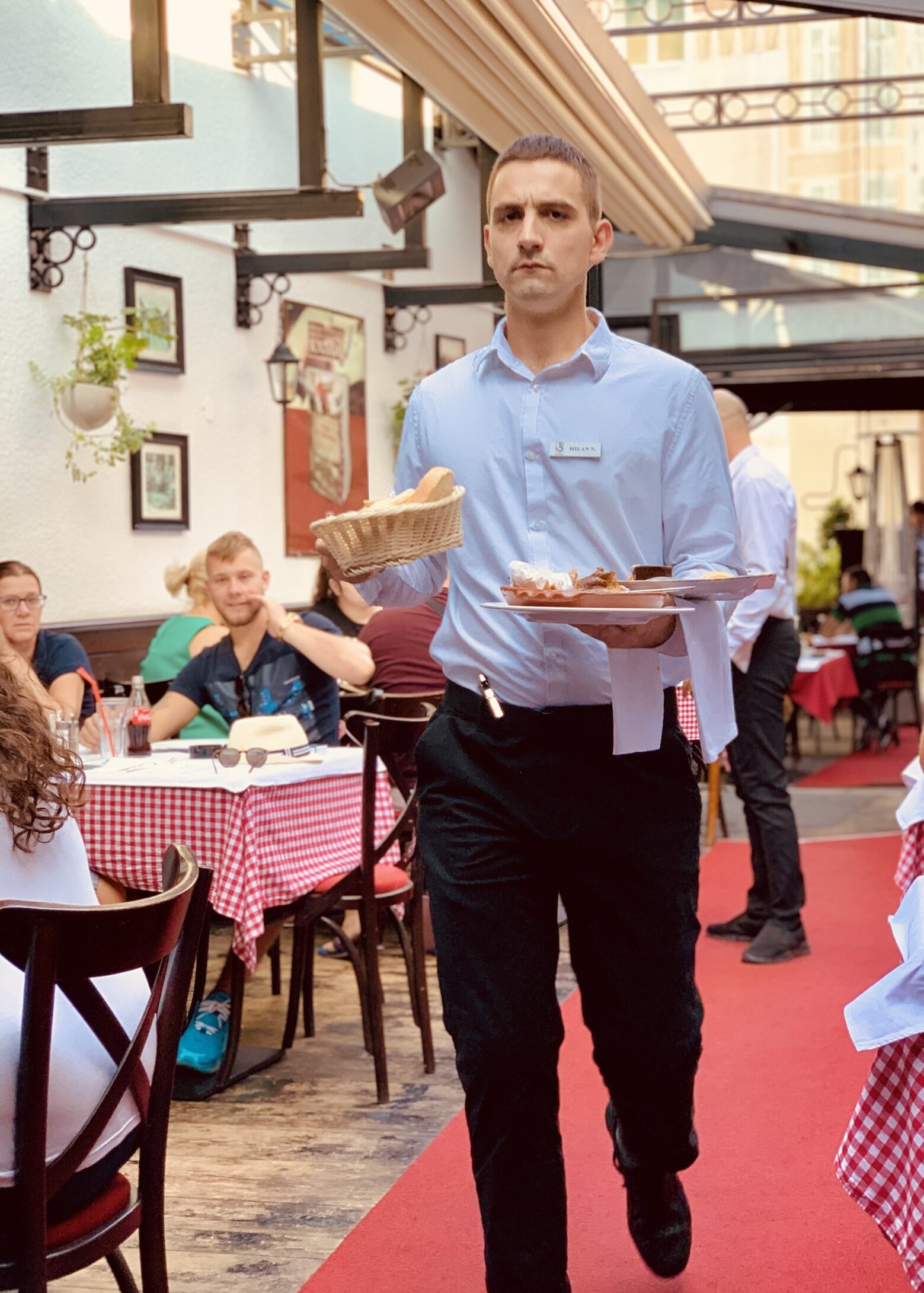 A busy waiter at Three Hats restaurant in Belgrade